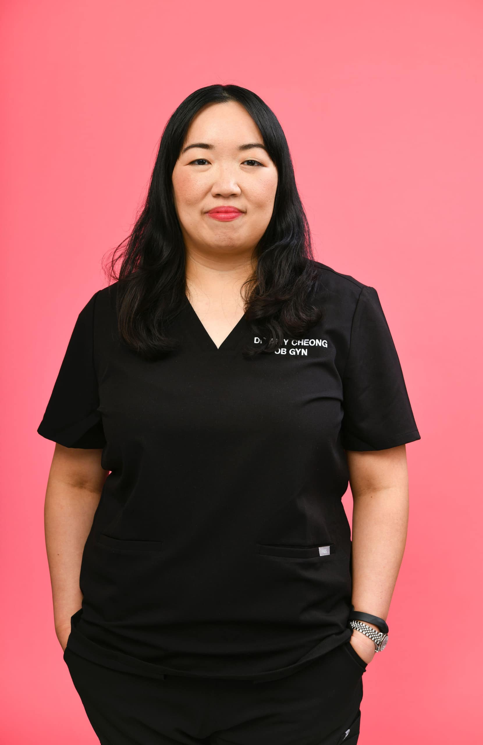 Member in scrubs on a pink background