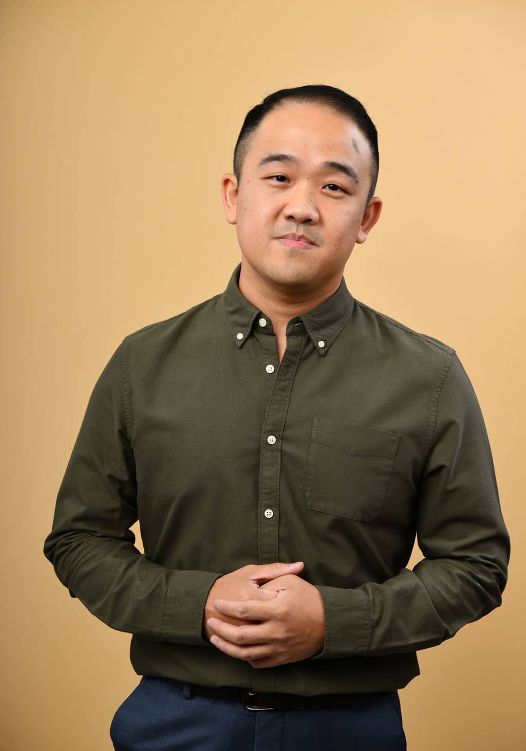 Portrait of Dr James Wong against a beige background