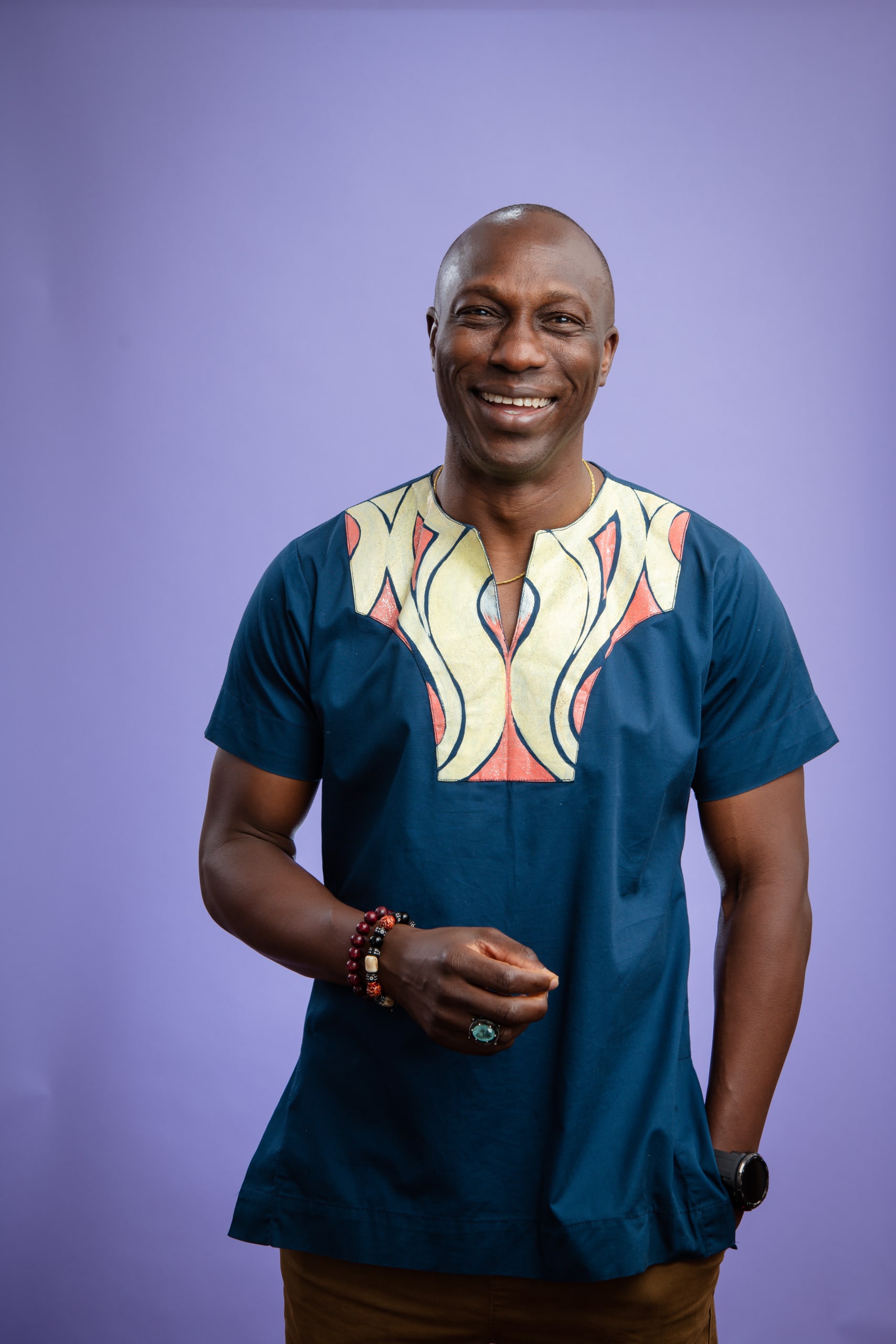 A portrait of Dr Efe Obudu against a purple background