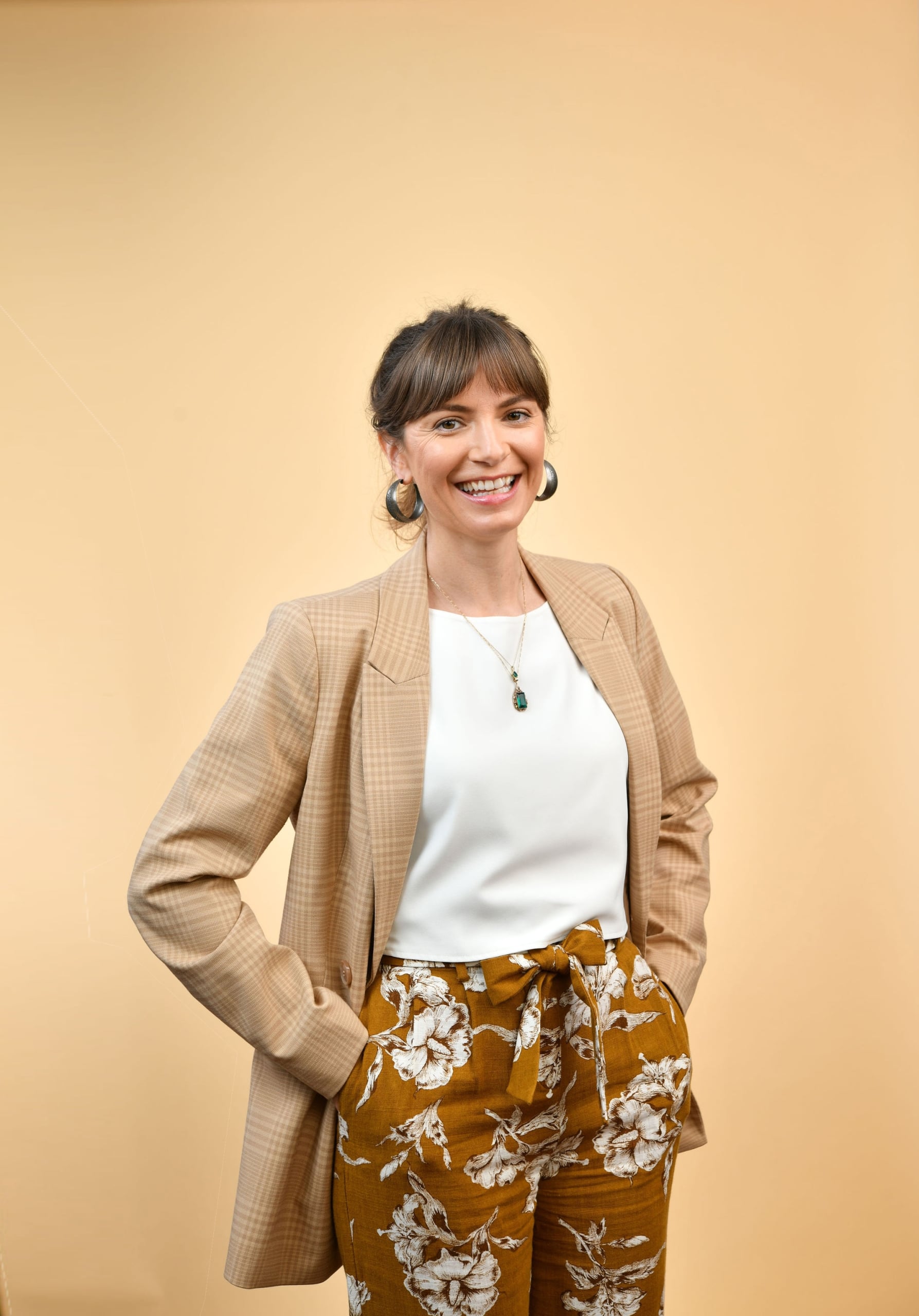 Portrait of DRANZCOG Dr Elysia Robb against a beige background